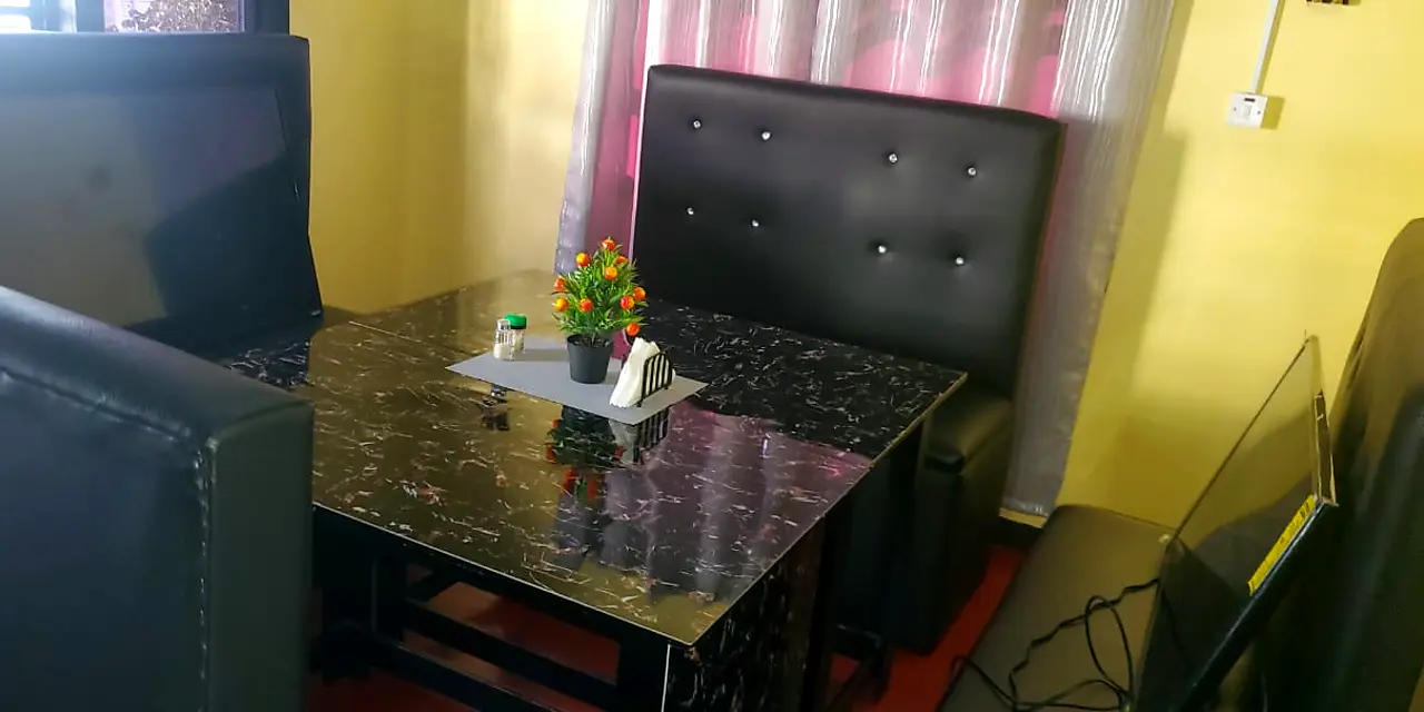 Black tufted restaurant booth with a marble-look table – Lynn's Furniture