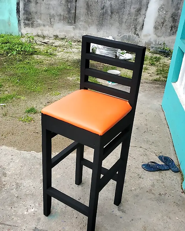 Black wooden bar stool with an orange padded seat – Lynn's Furniture