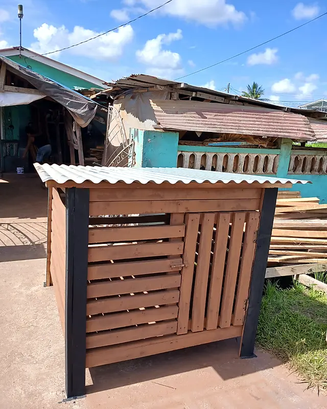 Brown slatted bin shelter with black posts and a white zinc roof – Lynn's Furniture