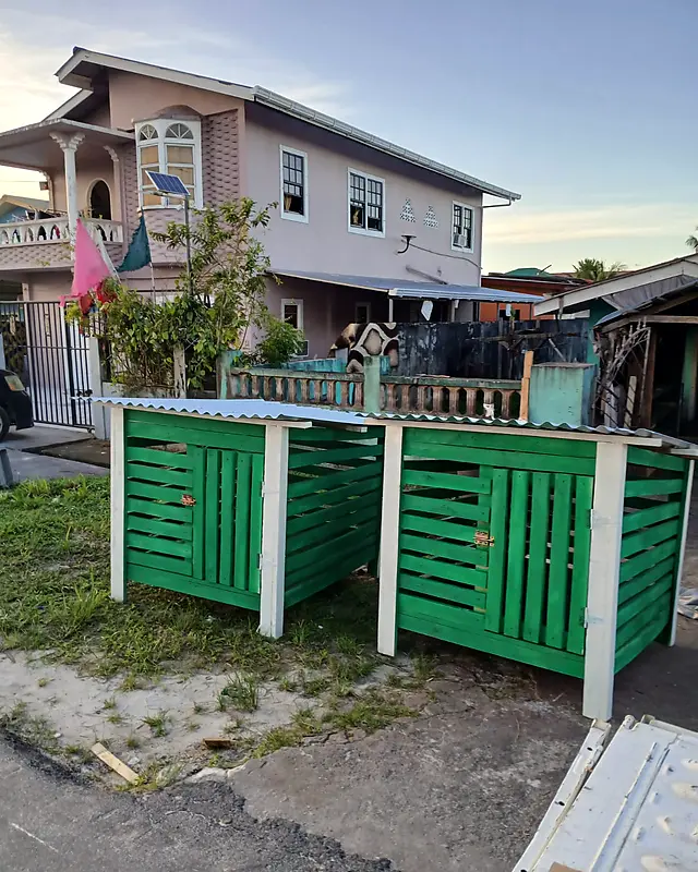 Two green bin shelters with white posts and zinc roofs – Lynn's Furniture
