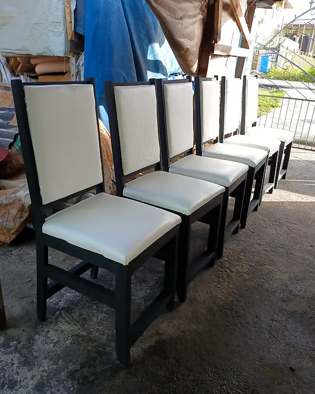 Row of black dining chairs with cream padded seats and backs – Lynn's Furniture