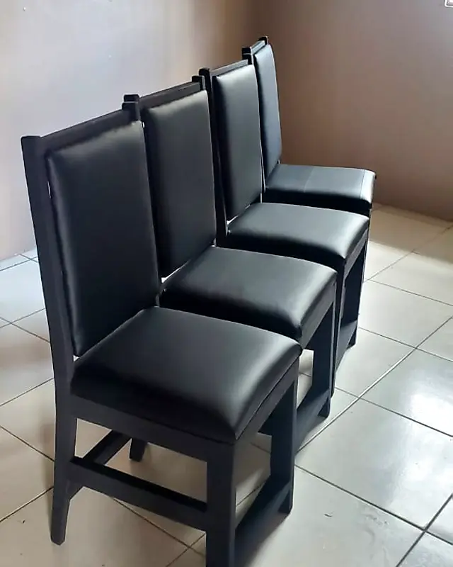 Row of black dining chairs with padded black seats and backs – Lynn's Furniture