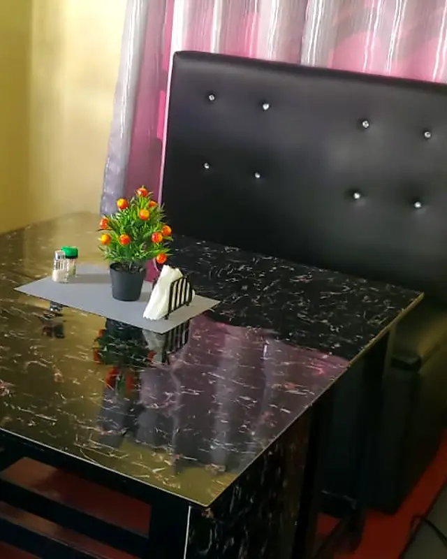 Black tufted restaurant booth with a marble-look table – Lynn's Furniture