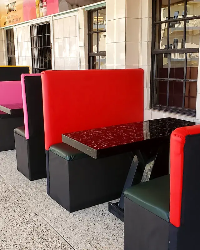 Red and black padded booths with tables outside a bar – Lynn's Furniture