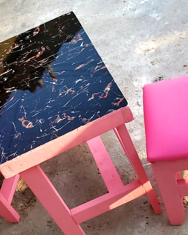 Pink café table with a marble-look top and two padded pink chairs – Lynn's Furniture
