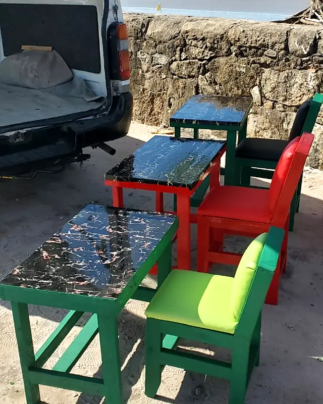 Green, red and black café table sets with marble-look tops by the sea wall – Lynn's Furniture