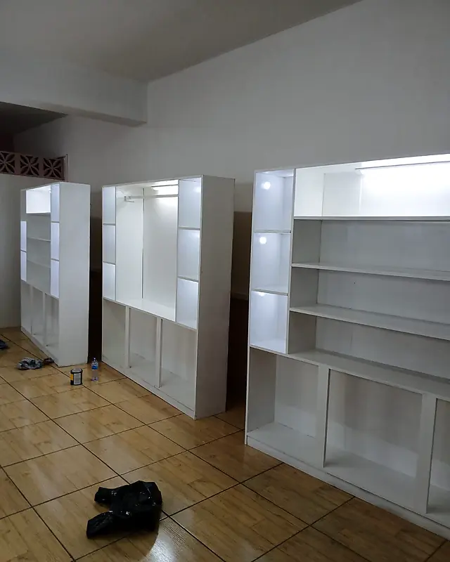 Three white display units with built-in lights in a store – Lynn's Furniture
