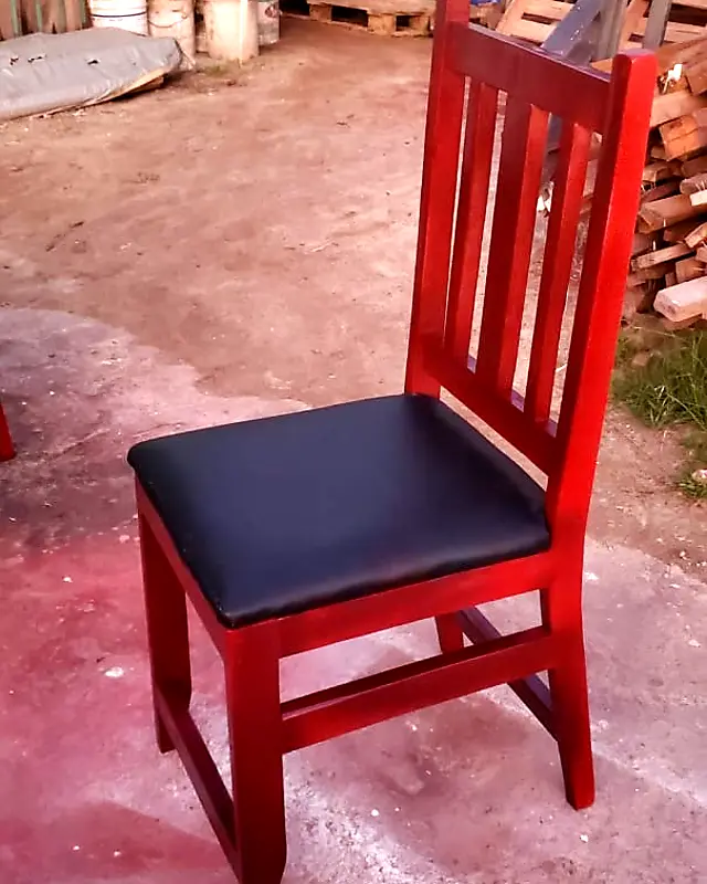 Red-stained slat-back dining chair with a black padded seat – Lynn's Furniture