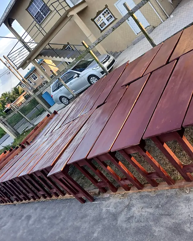 Many dark-stained wooden restaurant tables drying in the sun – Lynn's Furniture
