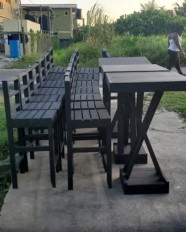Black slatted bar chairs lined up next to black bar tables – Lynn's Furniture