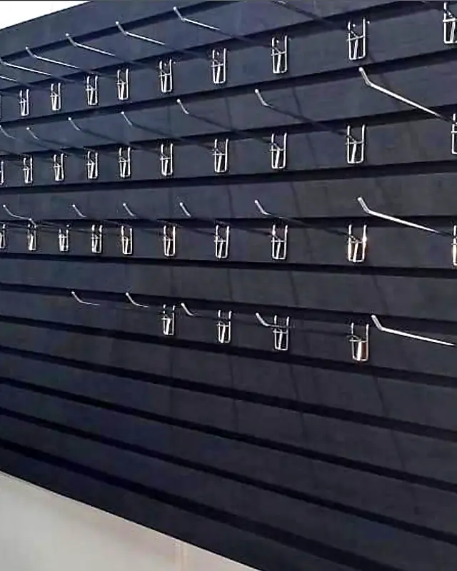 Dark slatwall display panel with metal hooks – Lynn's Furniture