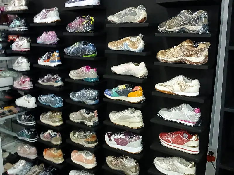 Black shoe display wall full of sneakers in a store – Lynn's Furniture