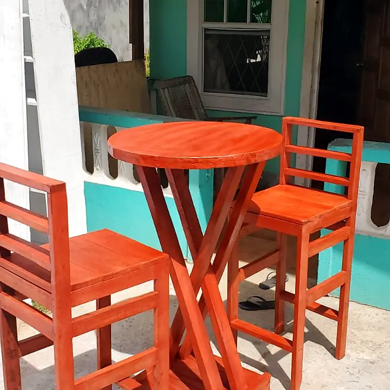 Orange round bar table and two bar chairs outside the workshop – Lynn's Furniture